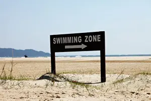 Indication Prints: It's a photo of a board sign that indicate the swimming zone in the beach of a hotel resort in Malaysia
