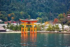 The Itsukushima Shrine Otorii Gate from the water at Miyajima Island, Hiroshima, Japan. (sign reads: Itsukushima Shrine)