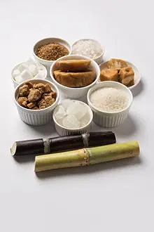 Cane Prints: Jaggery, Sugar Variety and Sugarcane - by-products of Sugar Cane or Ganna placed over moody background