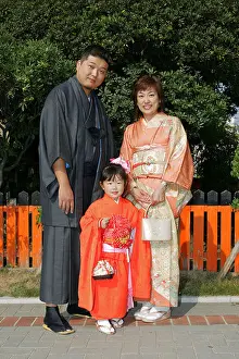 Osaka Prints: A Japanese family wearing traditional kimono clothes prepare for the Shichi Go San rights of passage childrens festival