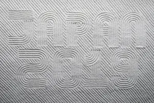 Kyoto Prints: Japanese Zen garden raked with the words JAPAN 2019 in capital letters in textured white sand