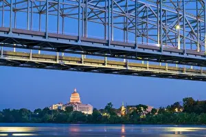 Jefferson City, Missouri, USA downtown view on the Missouri River with the State Capitol at dusk