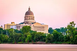 Jefferson City, Missouri, USA downtown view on the Missouri River with the State Capitol at dusk