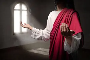 Praying Prints: Jesus christ raised hands with open palms and praying to god inside the room with light from outside the windows