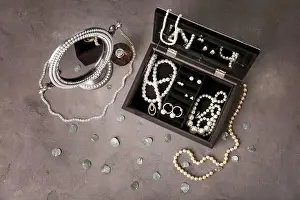 Perfume Prints: Jewelry accessories in box and table, top view