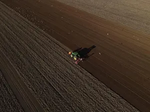 Seeding Prints: A John Deere Tractor seeds a previously cultivated field with sweetcorn