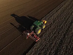 Seeding Prints: A John Deere Tractor seeds a previously cultivated field with sweetcorn