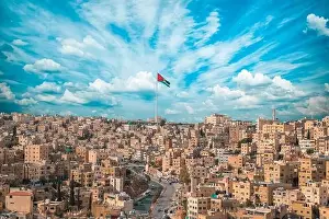 Jordanian Prints: Jordan flag in Amman, landscape view of cloudy sky background at the downtown