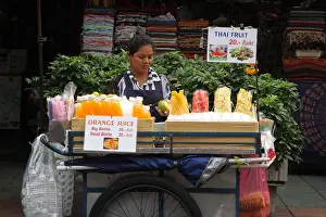 Merchant Prints: Juice and fruit seller on street at Khao San road in Bangkok, Thailand