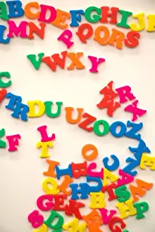 Infants Prints: A jumble of colorful magnetic alphabet letters on a white board in a classroom