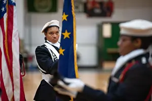 Indiana Prints: A Junior Reserve Officer Training Corps cadet looks at the Indiana state flag during a color guard performance