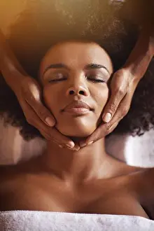 Black Woman Prints: This is just what she needed. Shot of a young woman getting a head massage at a beauty spa