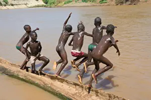 Kara tribe boys on dugout canoe on Lower Omo River, South Omo, Ethiopia