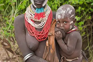 One Woman Prints: Karo woman with colorful necklaces holding a suckling baby
