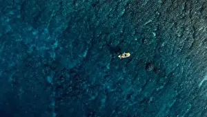 Kayaking on transparent kayak in blue ocean. Aerial view
