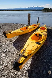 Kayaking Prints: Two kayaks on the shore of the Okarito lagoon a large coastal sea lake in New Zealand's South Island