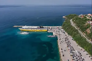 Cephalonia Prints: Kefalonia, Greece - August 22, 2019: Aerial drone shot of cars in queue for embarkement in cruise ship in Poros