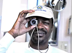 Injured Prints: Kenneth Holmes an army veteran from Philadelphia uses a high powered monocle as he works with low vision specialist