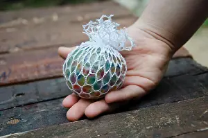 Anxious Prints: kid holding stress relief grape balls
