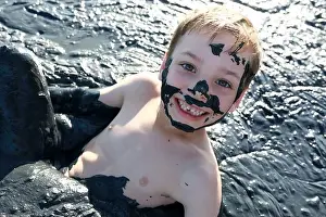 Pond River Prints: Kid lying in healing mud, Primorsko-Akhtarsk, Russia