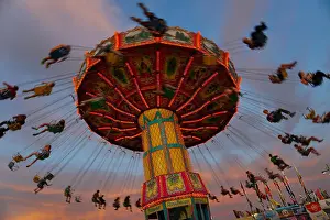 Rotate Prints: Kids enjoy a giant swing ride at a local carnival