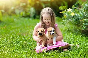 Preschooler Prints: Kids play with cute little puppy