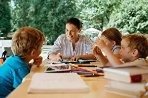 Educate Prints: Kids during a reading lesson outside in a park