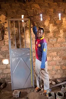 Village Life Prints: Kiniero, Guinea, 30th April 2015: Metal and welding workshop making doors and doing repairs