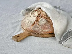 Loaf Prints: No knead handmade loaf on cutting board on textile with linen towel