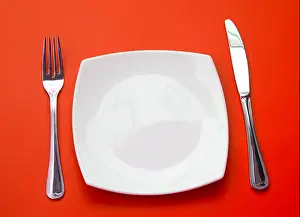 Silverware Prints: Knife, square white plate and fork on red background