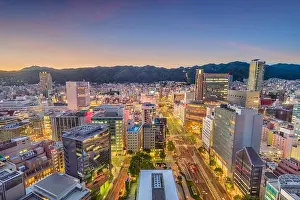 Kobe, Japan skyline over Flower Road and the Sannomiya District towards Mount Rokko at dusk