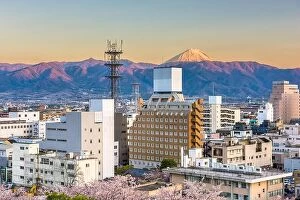 Images Dated 13th April 2017: Kofu, Japan city skyline with Mt. Fuji peaking over the mountains at dusk