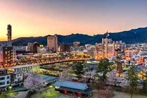Kofu, Yamanashi, Japan downtown cityscape at dusk with spring foliage