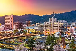 Kofu, Yamanashi, Japan downtown cityscape at dusk with spring foliage