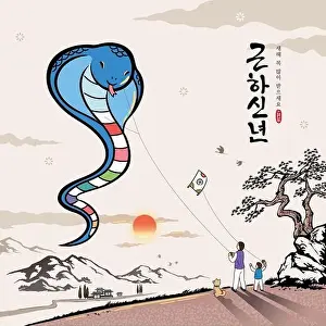 Korean New Year. A Korean family is flying a blue snake-shaped kite to welcome the New Year
