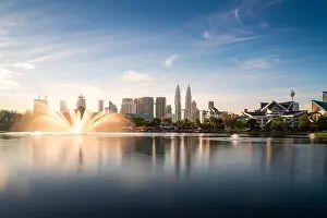 Kuala Lumpur city skyscraper and fountation with nice sky morning at Titiwangsa Park in Kuala Lumpur. Malaysia. Travel and Vacation concept