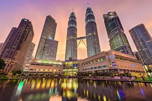 Petronas Prints: KUALA LUMPUR - SEPTEMBER 20, 2015: The Petronas Towers viewed from KLCC Park at twilight