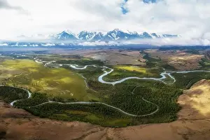 Kurai steppe and Chuya river on North-Chui ridge background. Altai mountains, Russia. Aerial drone panoramic picture