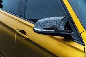 Stock Photos Prints: KYIV-15 MAY, 2021: Tuned BMW M3 F80 Sport Car rear view mirrors made of carbon fiber and vinyl wrapping