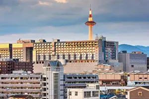 Kyoto, Japan downtown cityscape towards the train station and tower at dusk