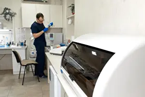 Automated Prints: Laboratory assistant make test blood in automatical blood sample analyzer