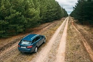 Aerial Landscape Collection: Lada Vesta Parked On Roadside. Country Road Through Forest