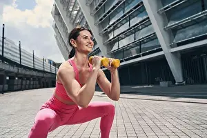 Squat Prints: Lady doing fitness activity while using dumbbells