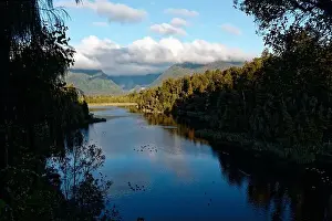 Water Fowl Prints: Lake Matheson stretches into the distant hills while waterfowl rest on its surface