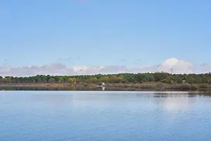 Forest River Prints: Lake view of a camper van with solar panel living van life panorama landscape with reflection on the water in Marateca