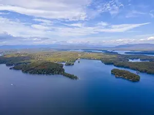 Lake Winnipesaukee and village of Weirs Beach aerial view with fall foliage in City of Laconia, New Hampshire NH, USA