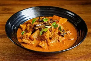 Potatoes Prints: Lamb meat cooked in thick curry with potatoes and spices and garnished with curry leaves