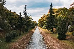 Albania Prints: The Lana river flows through a concrete canal in central Tirana, Albania