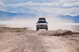 Tibet Prints: Land Cruiser in a cloud of dust on the road from Gerze to Tsochen