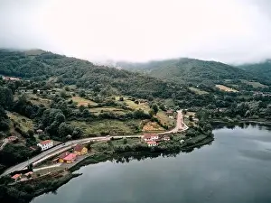 landscape of the reservoir from a drone near the road and the forest vegetation on a cloudy day